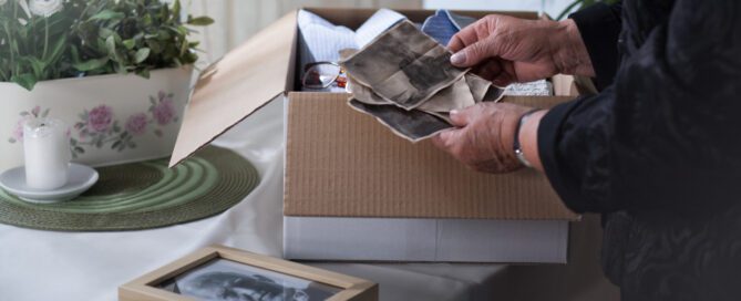 Women organizing photos of deceased husband