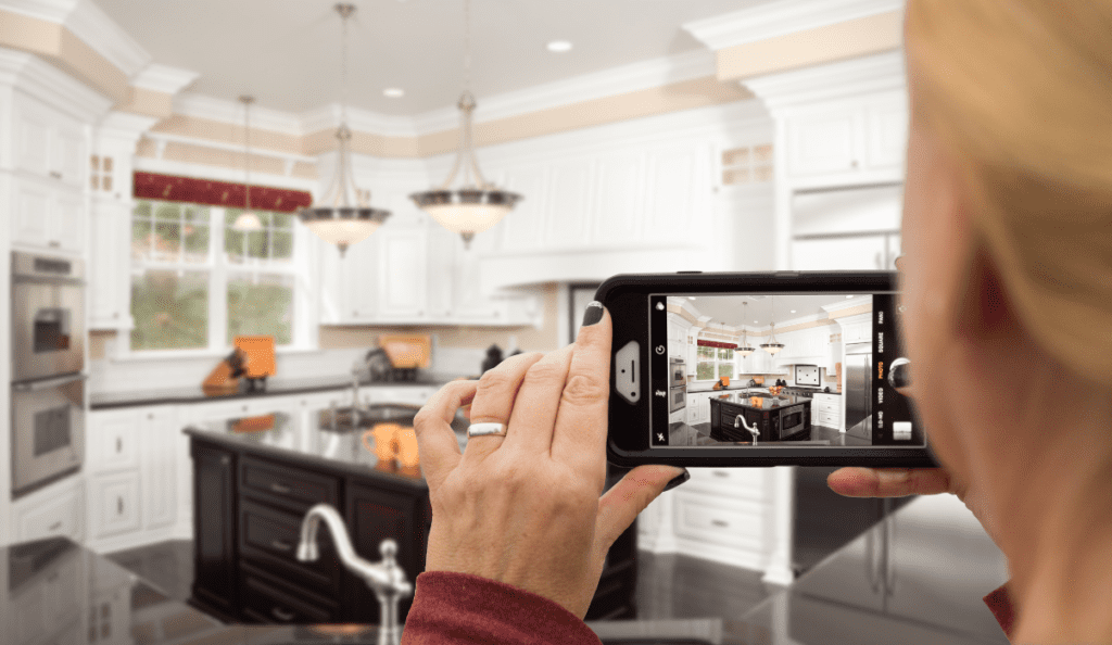 woman taking picture of her kitchen