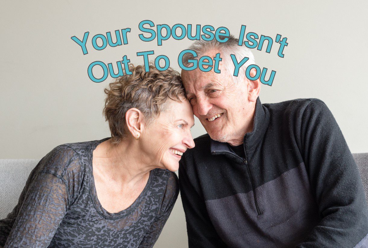 Older couple snuggling a little with caption that says Your Spouse Isn't Out To Get You