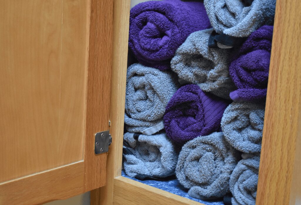 Extra rolled up towels in a cupboard