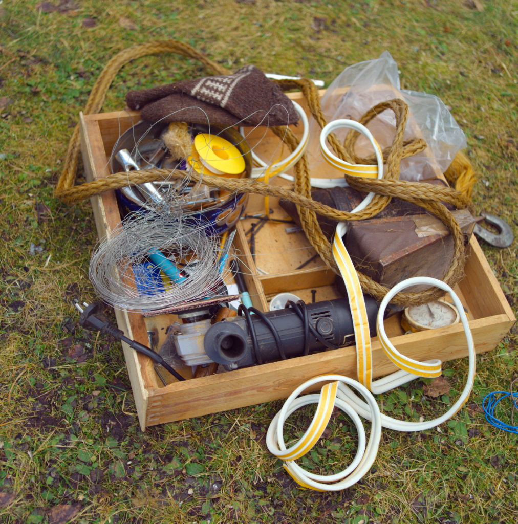 Collection of stuff from the garage placed in a box on the lawn