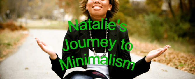 Black woman sitting cross-legged in middle of road with a book on her knee, a smile on her face, and her hands widespread facing the sky