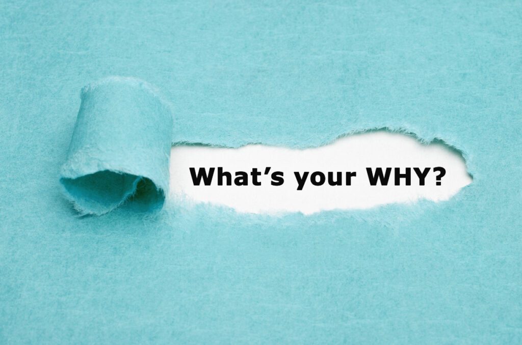 Tiffany-blue wrapping paper with a piece pulled back to reveal the words "What's your WHY?"