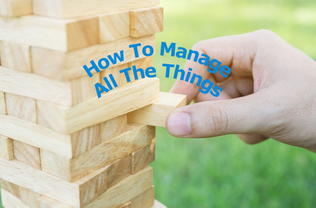 Picture of a hand pulling a piece of wood out of a Jenga stack