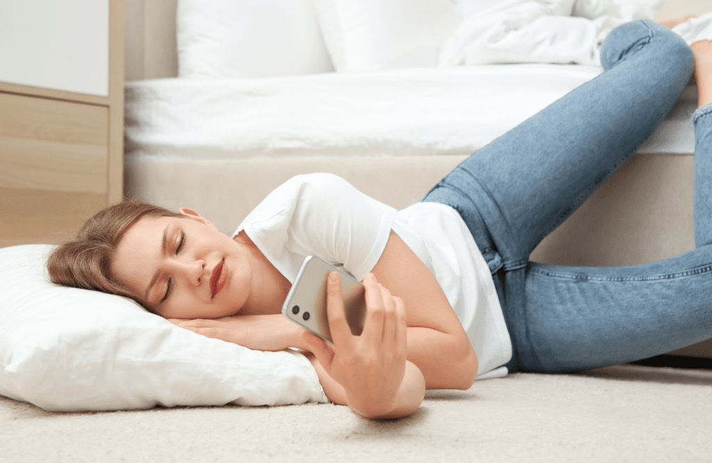 young woman relaxing while looking at her cell phone