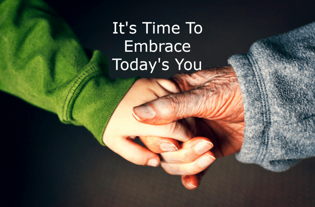 A young woman's hand grasps an old woman's hand against a dark background