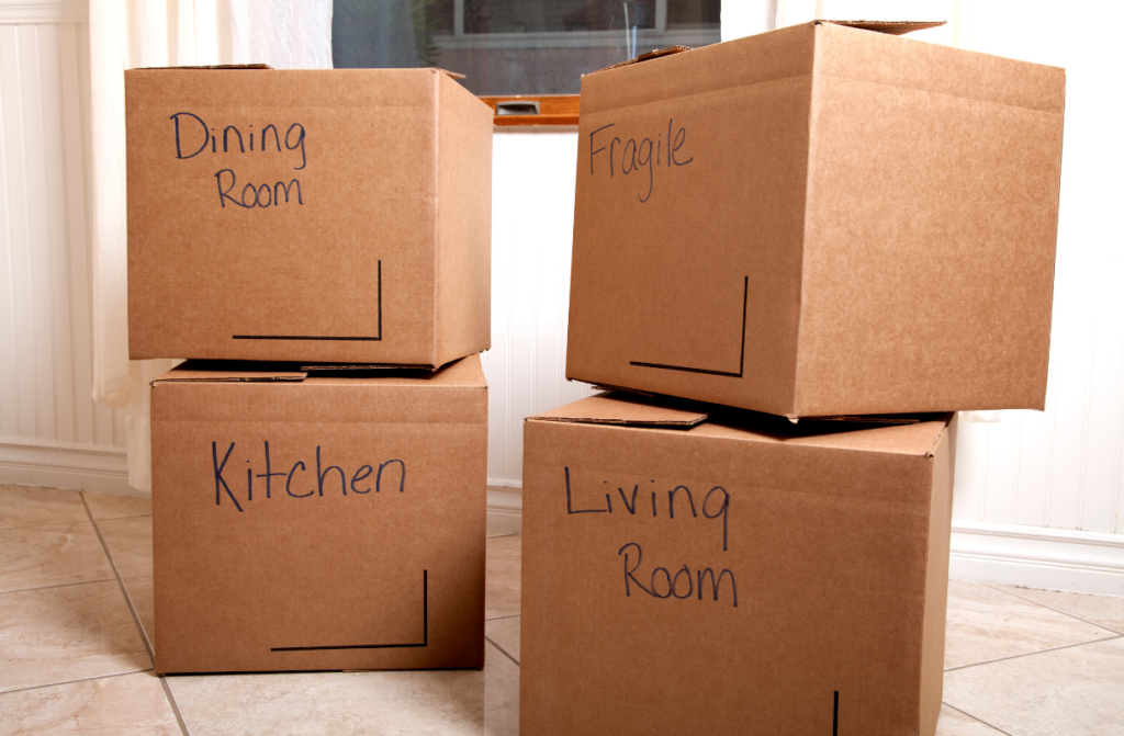 4 moving boxes labeled with various rooms.
