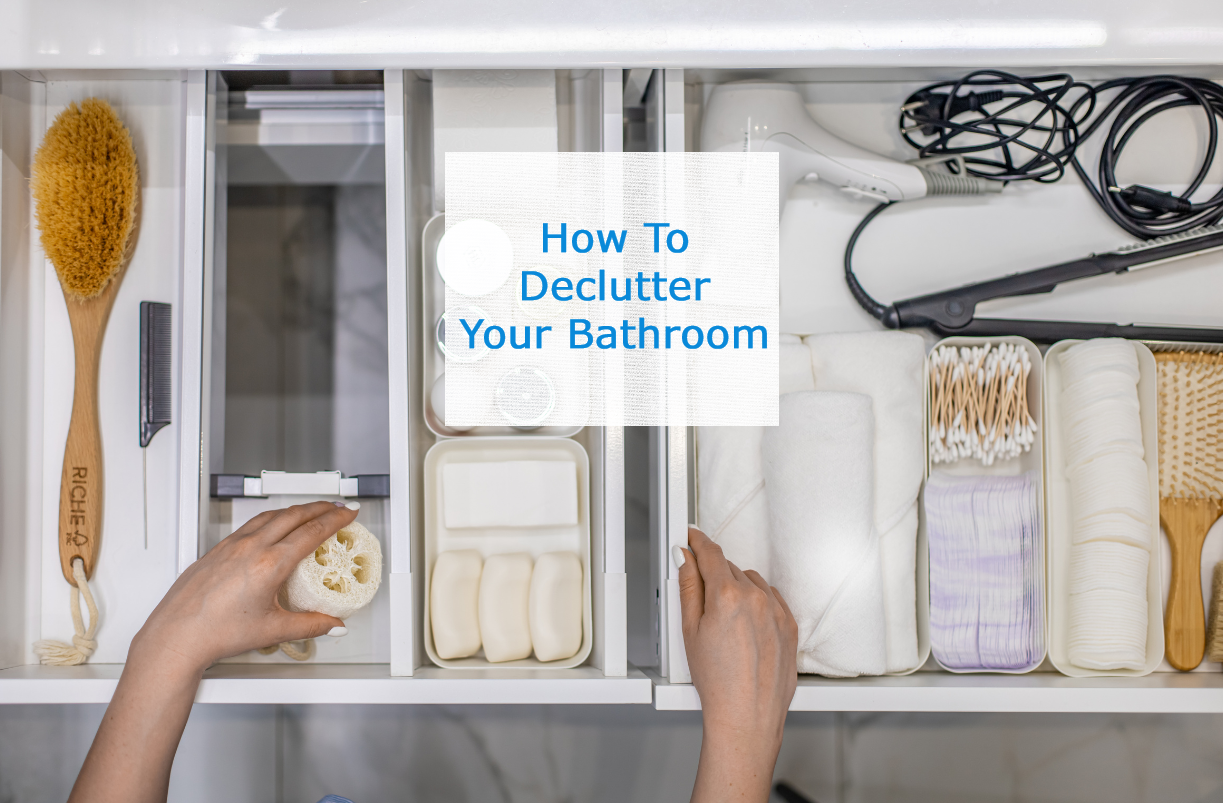 Woman's hands pulling something out of a very organized bathroom drawer with text saying ' How To Declutter Your Bathroom'