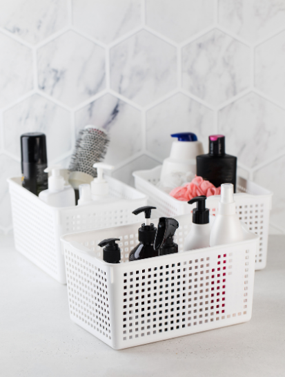 white plastic baskets to be used for bathroom storage