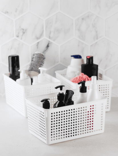 white plastic baskets to be used for bathroom storage