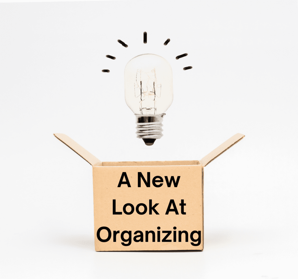 Cardboard box with a light bulb over it and words on it saying 'A New Look At Organizing'