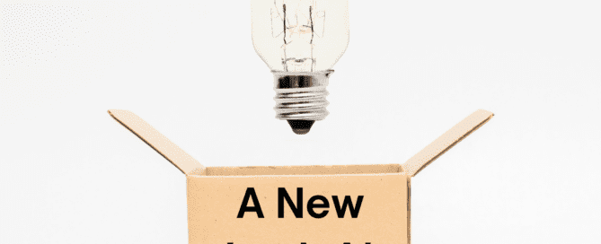 Cardboard box with a light bulb over it and words on it saying 'A New Look At Organizing'