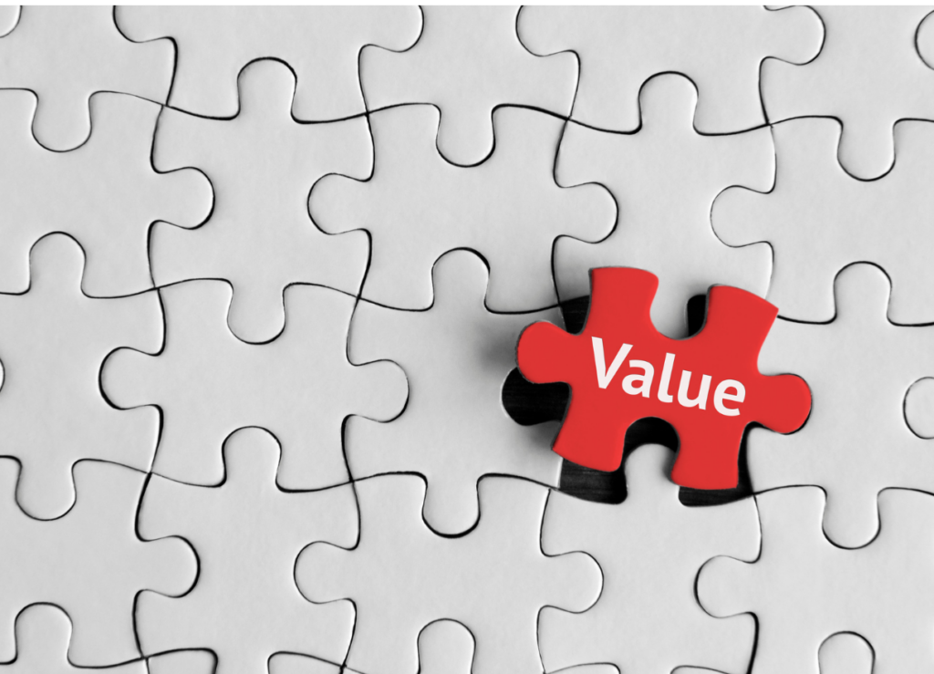 A puzzle with all light gray puzzle pieces and 1 red puzzle piece that says 'value'