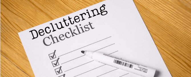 Piece of paper on a desk that has check boxes and the words "Decluttering Checklist" at the top