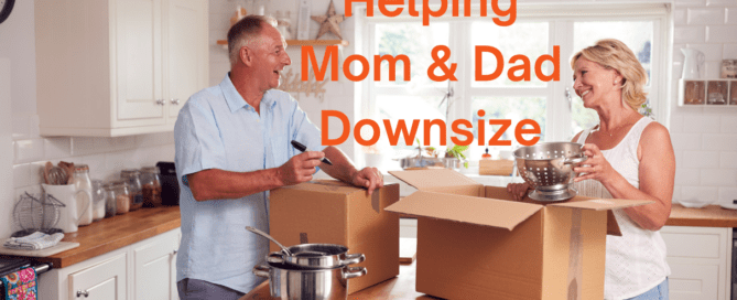 Senior dad and daughter standing in kitchen packing boxes as he downsizes