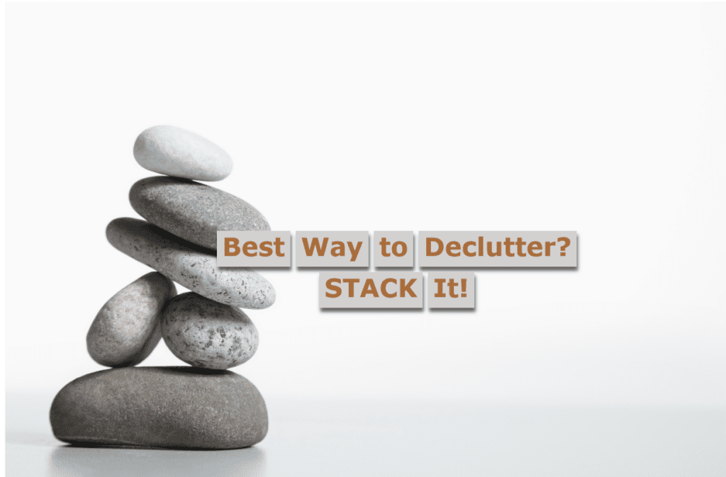 Stack of small, grayish stones against a light gray background with the title "Best Way To Declutter? STACK It!"