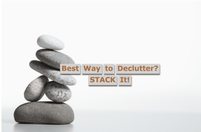 Stack of small, grayish stones against a light gray background with the title "Best Way To Declutter? STACK It!"