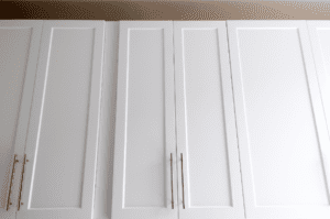 Very tall white kitchen cabinets from the perspective of looking up to the top